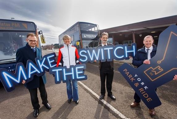 Councillors and First staff holding promotional signage
